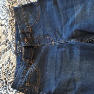 Arizona jeans with distressed bottoms.